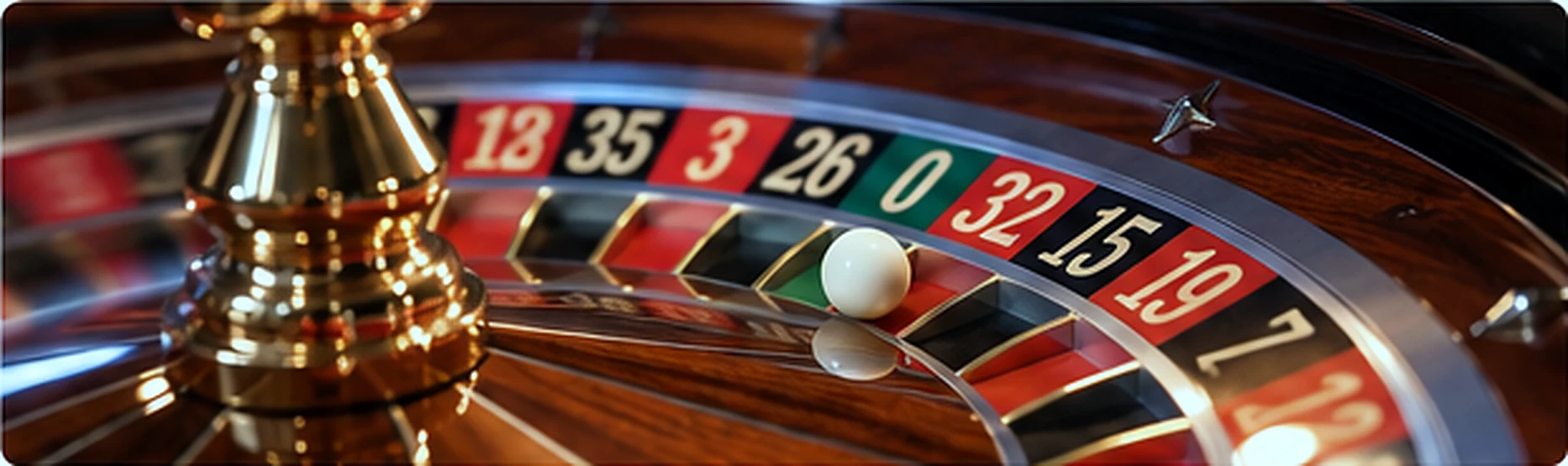 Close-up of a roulette wheel, numbered pockets and white ball at a live casino table